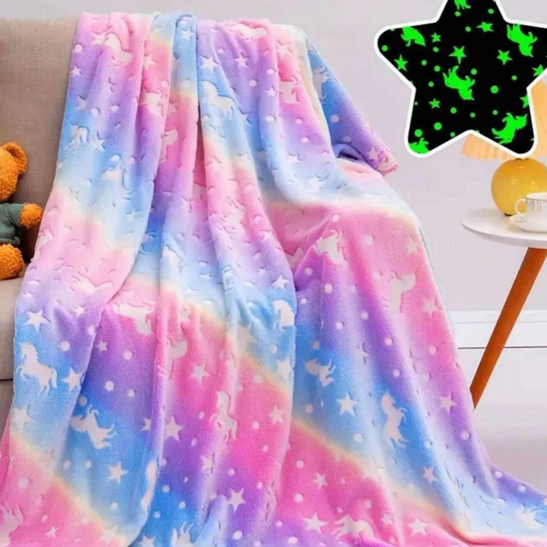 Svetleće ćebe, sa motivima unicorna, šarene boje, rašireno na krevetu